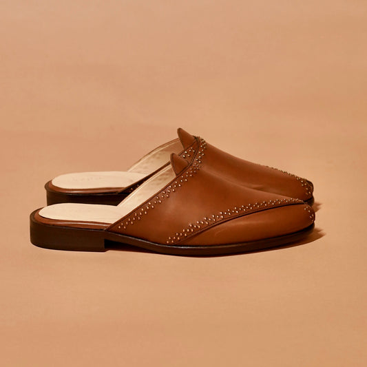Side profile of open-front brown mule with anti-skid sole and leather detailing