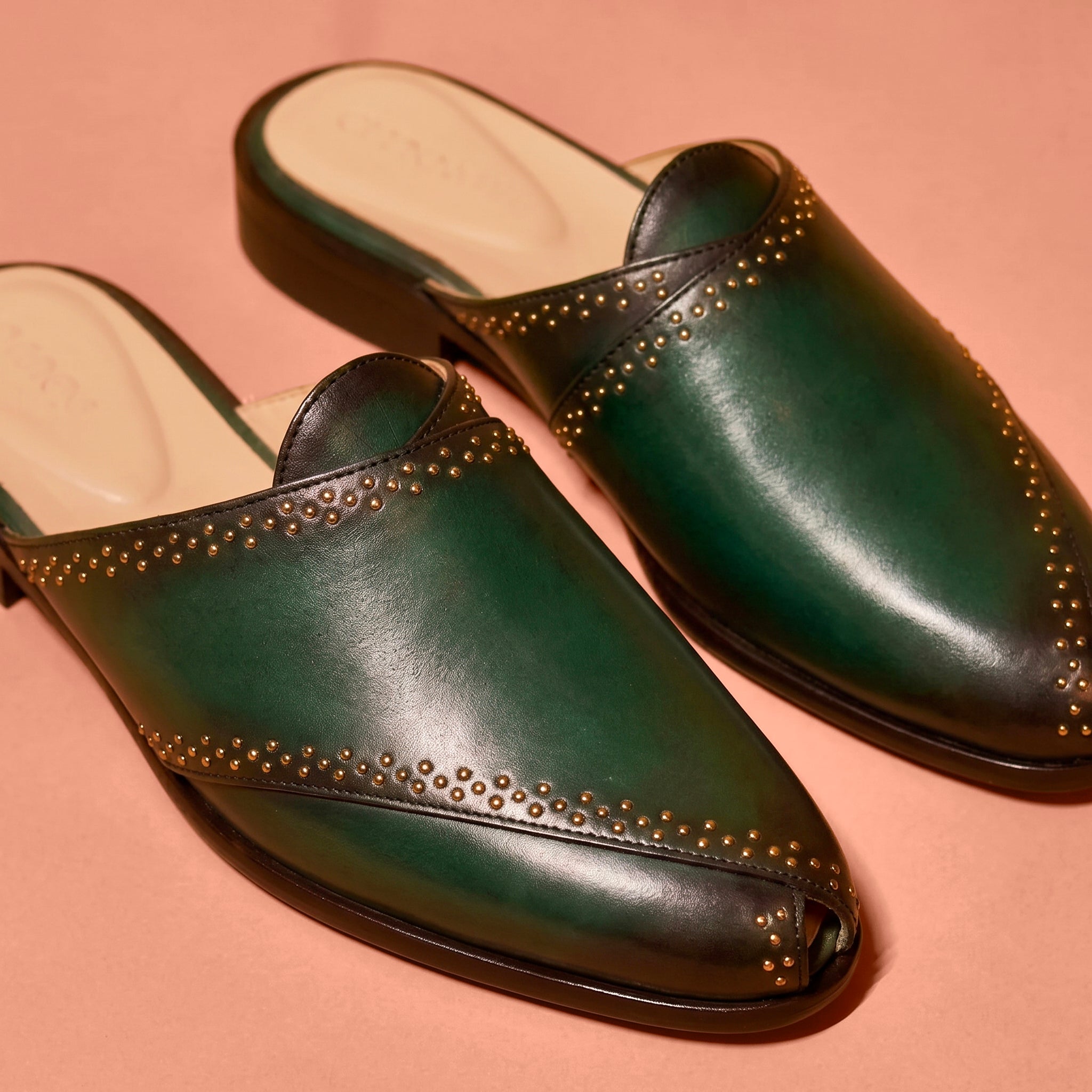 Close-up of golden stud accents and dark green leather detailing on Hoffler Verde Scuro