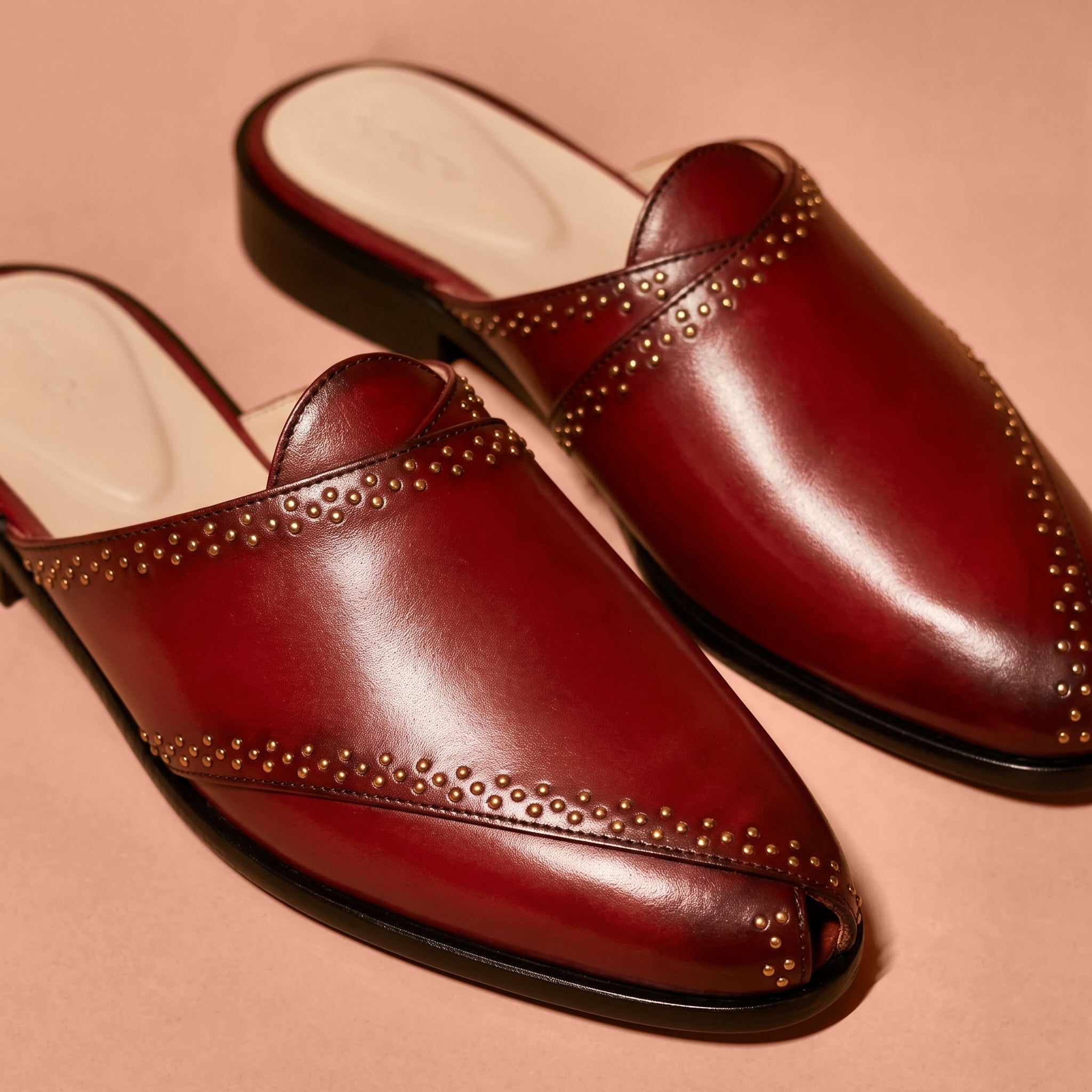Close-up of golden rivet accents on Hoffler Rossa Riveto