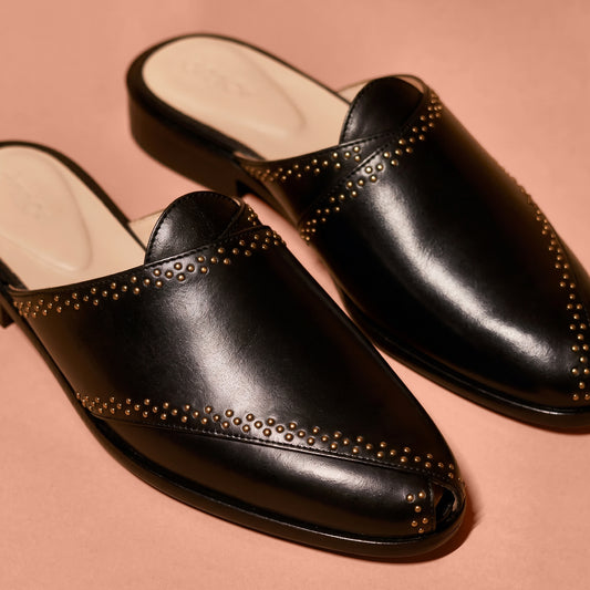 Close-up of golden rivet accents and black leather detailing on Hoffler Pesha Nero