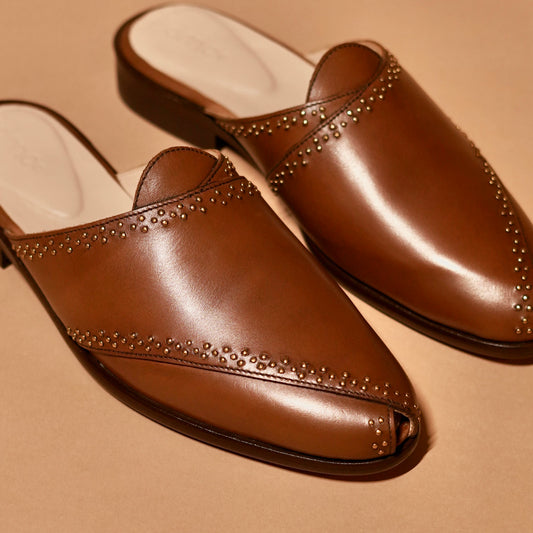 Close-up of hand-painted brown leather and antique rivet work on Hoffler Bruno Riveto