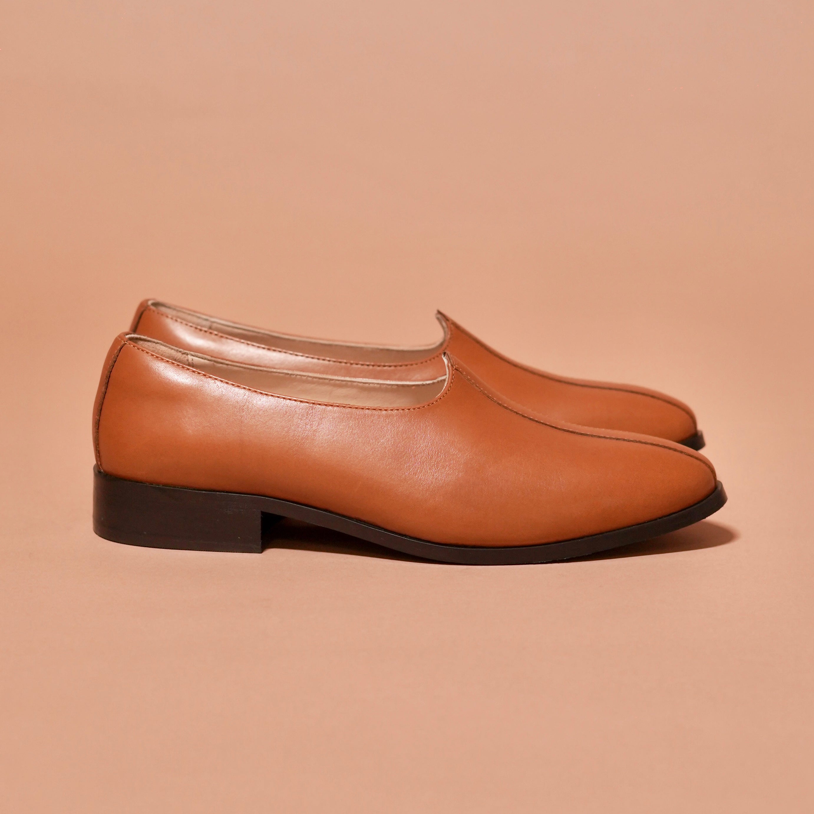 Side view of Ethnico Cacao Mojari showing minimal silhouette and tan leather