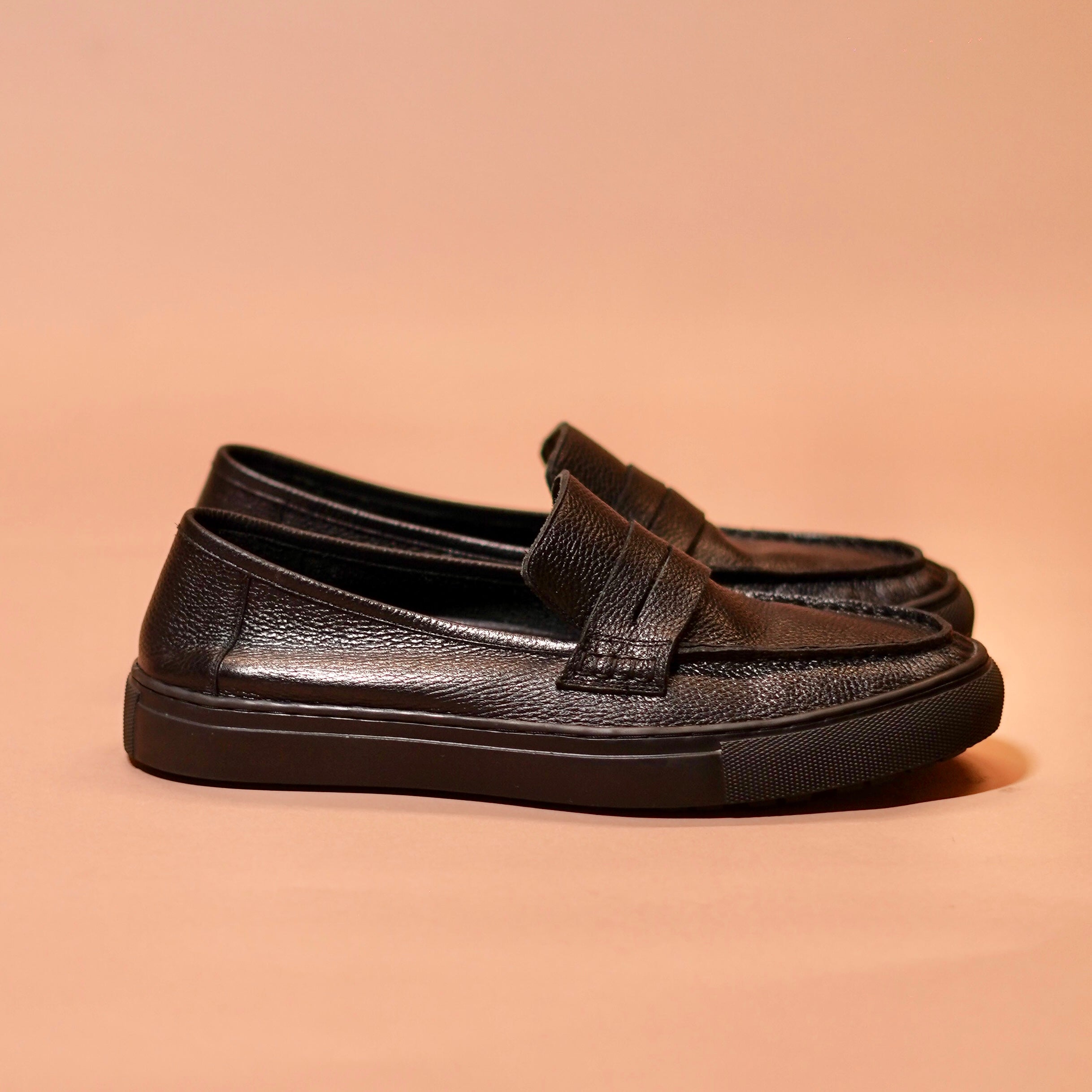 Side view of Tristo showcasing black milled leather and sneaker sole