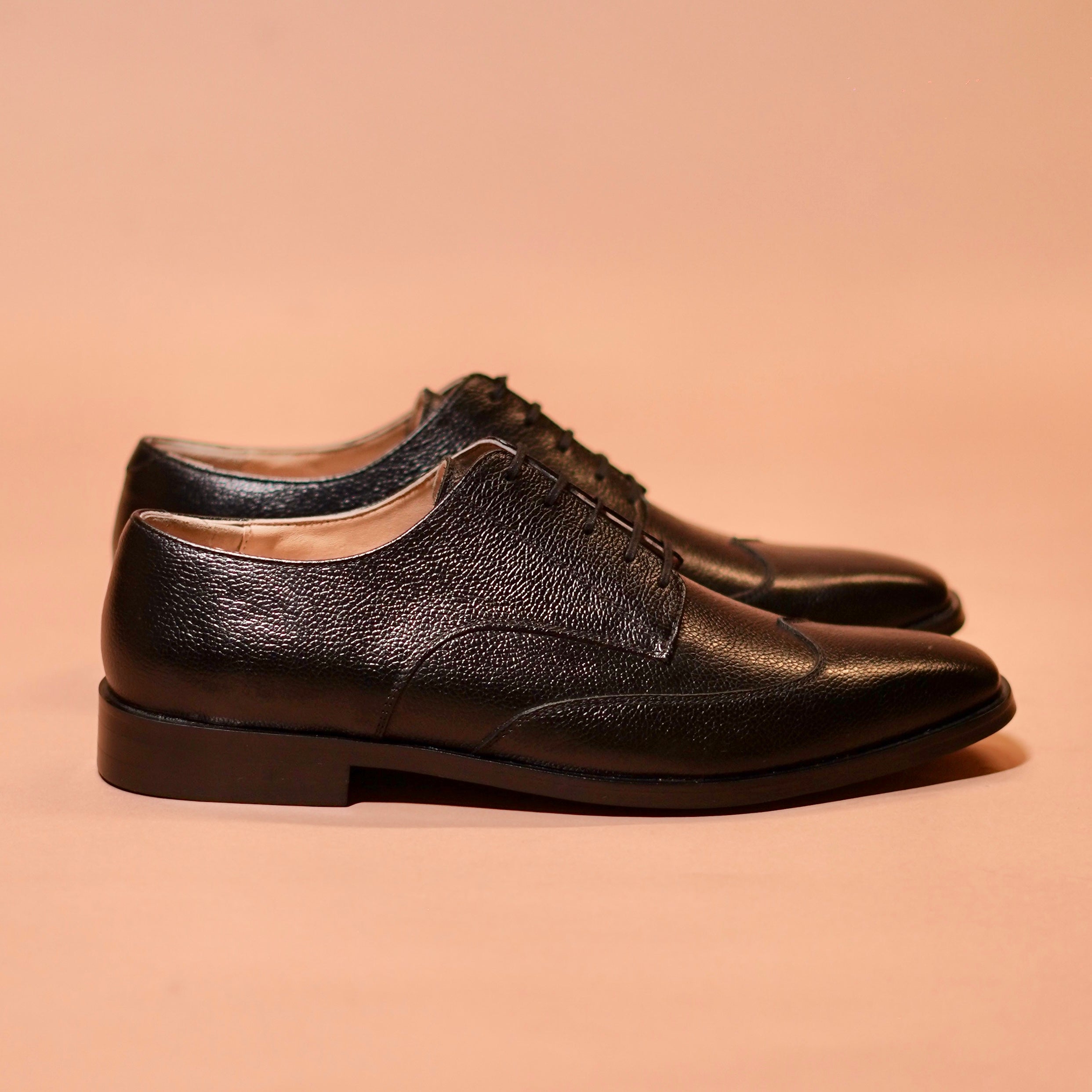 Side view of Carbo Nero showing soft milled leather and wingtip design