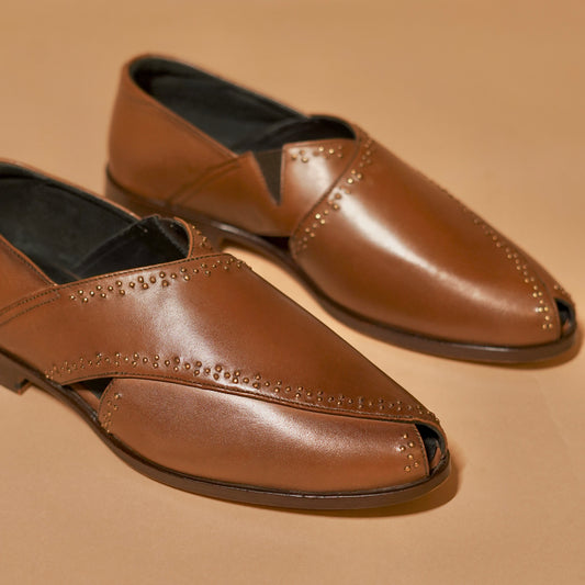 Close-up of leather texture and metal rivets