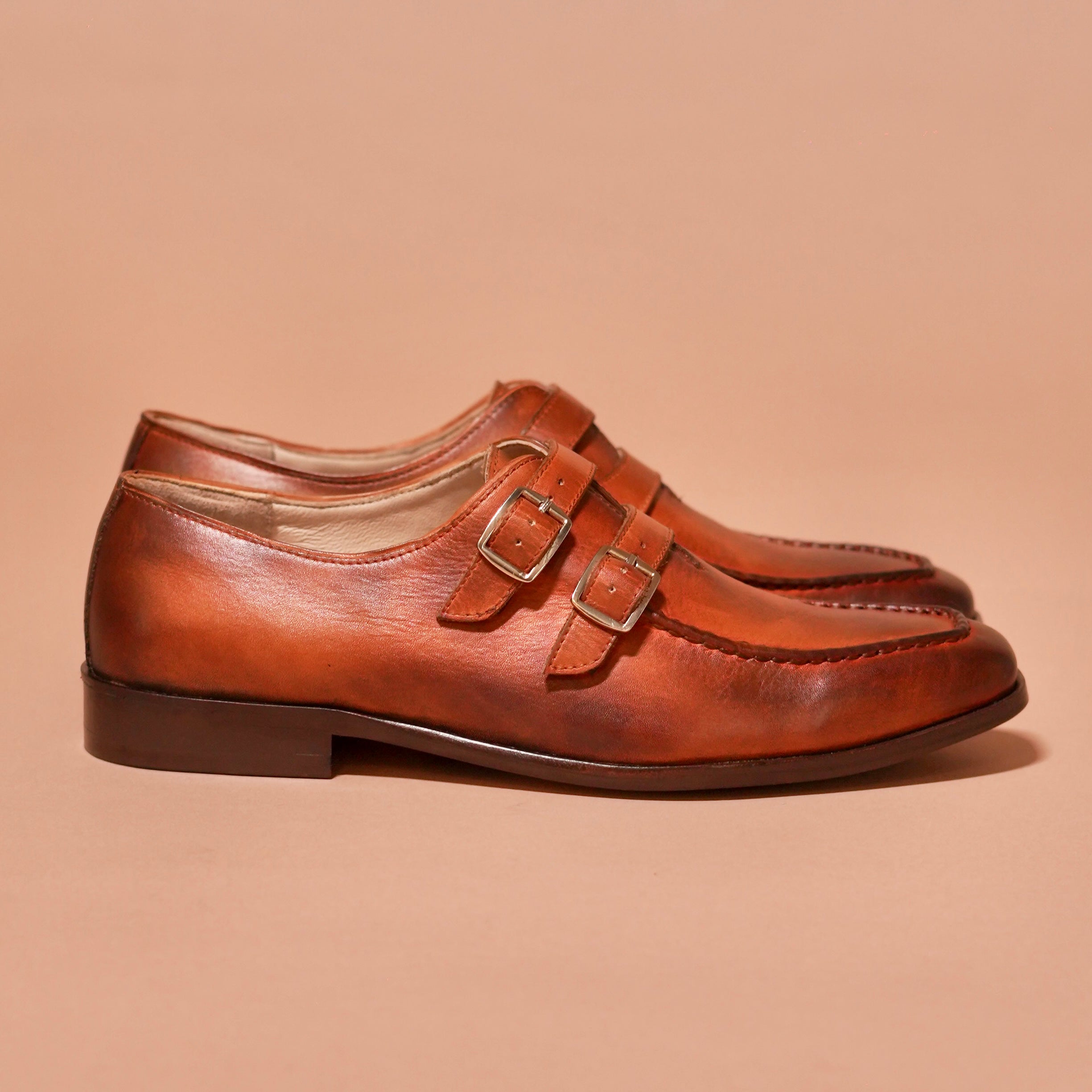 Side view of Motivo Strappo Bruno showcasing dual-tone patina and buckle straps
