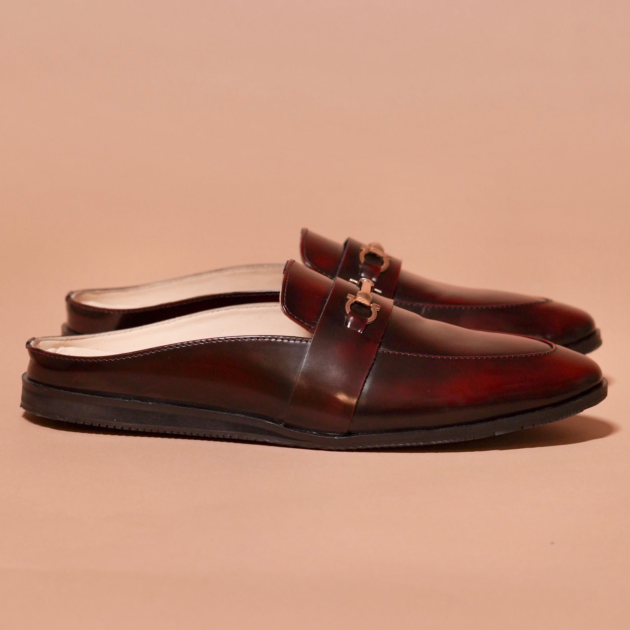 Side view of Hoffler Borgogno mule showing brush-off cherry leather and gold buckle