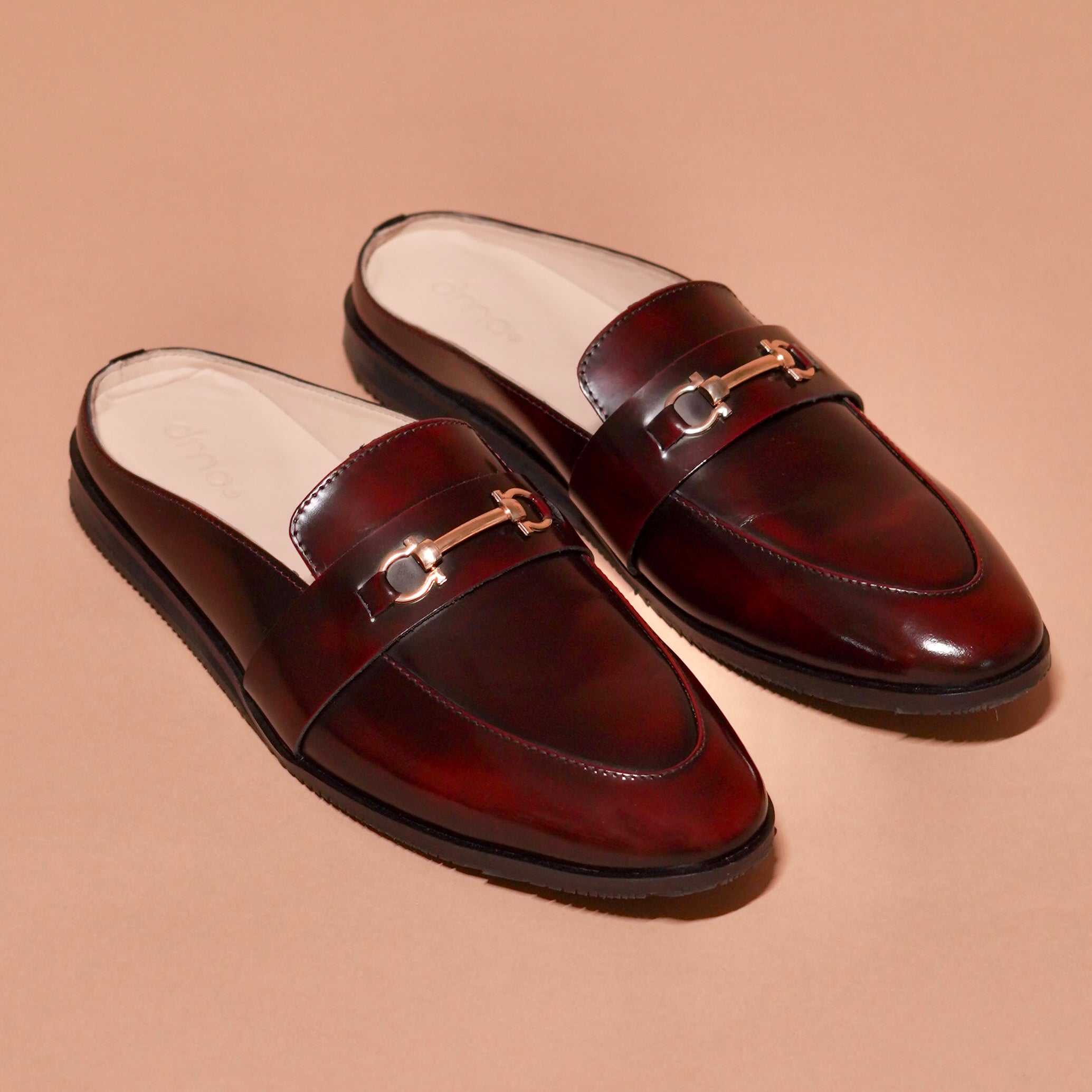 Side view of Hoffler Borgogno mule showing brush-off cherry leather and gold buckle