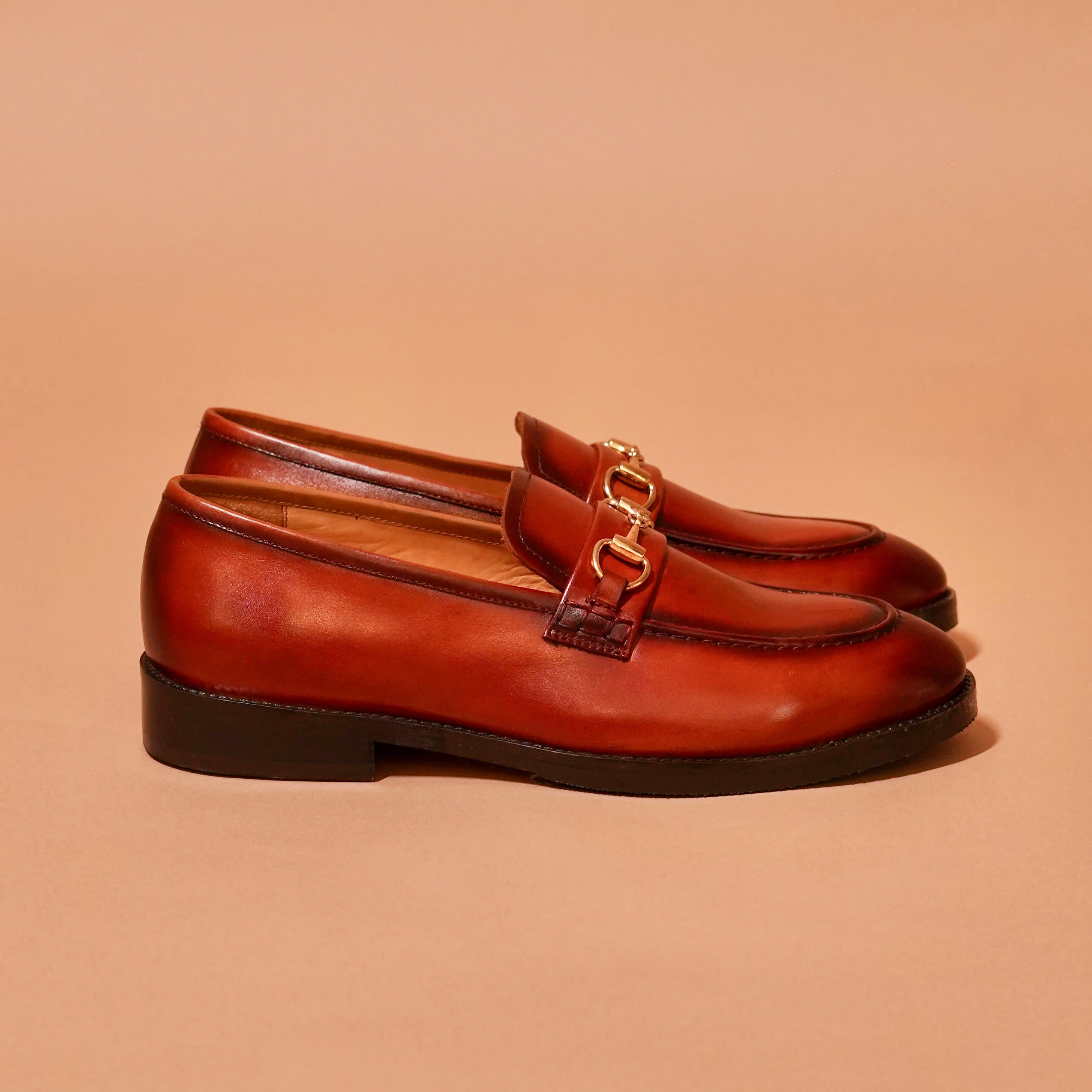 Side view of Moccasino Fibio Bruno showing dual-tone finish and horsebit buckle