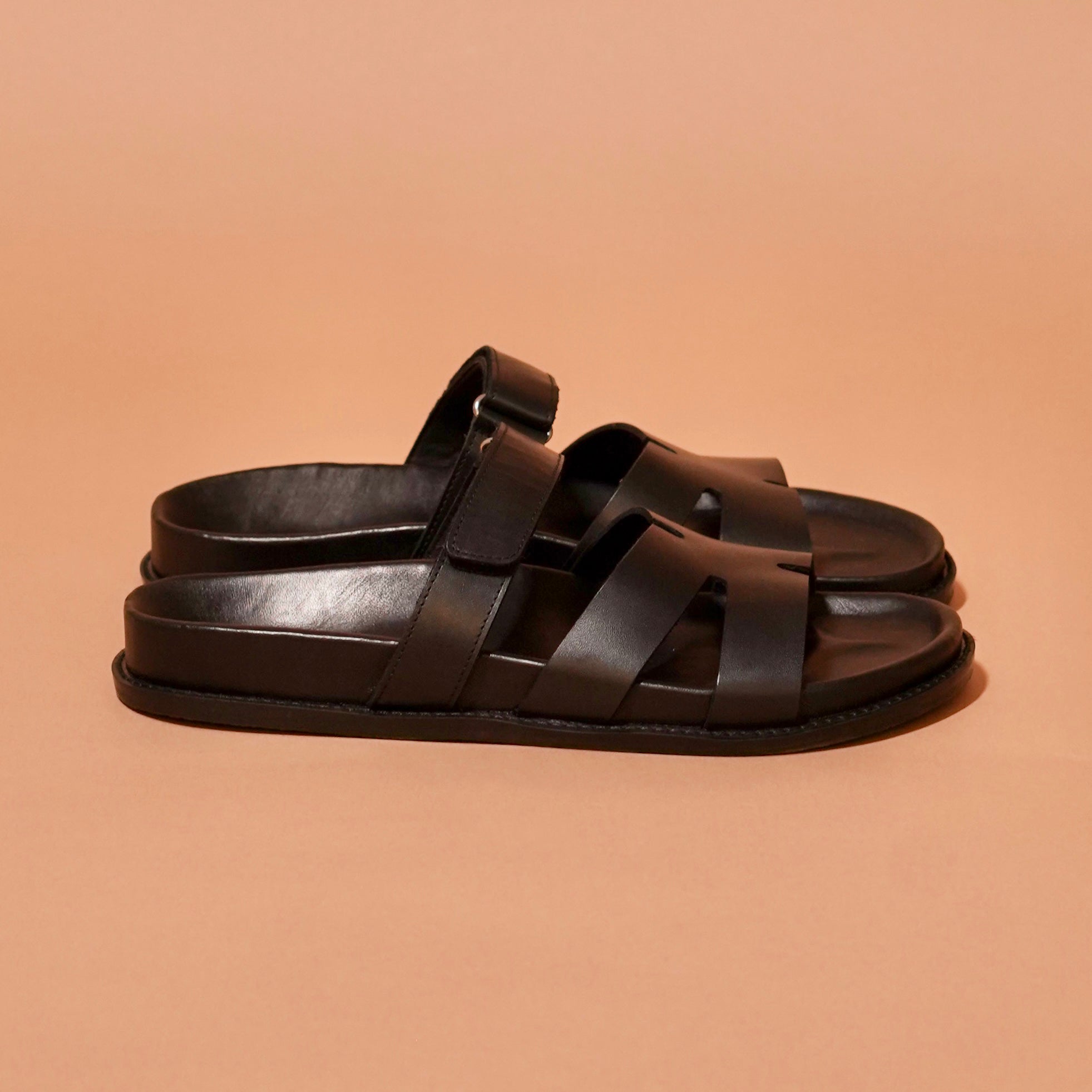 Side view of Pelle Corko Carbonio showing black dual-strap sandal design