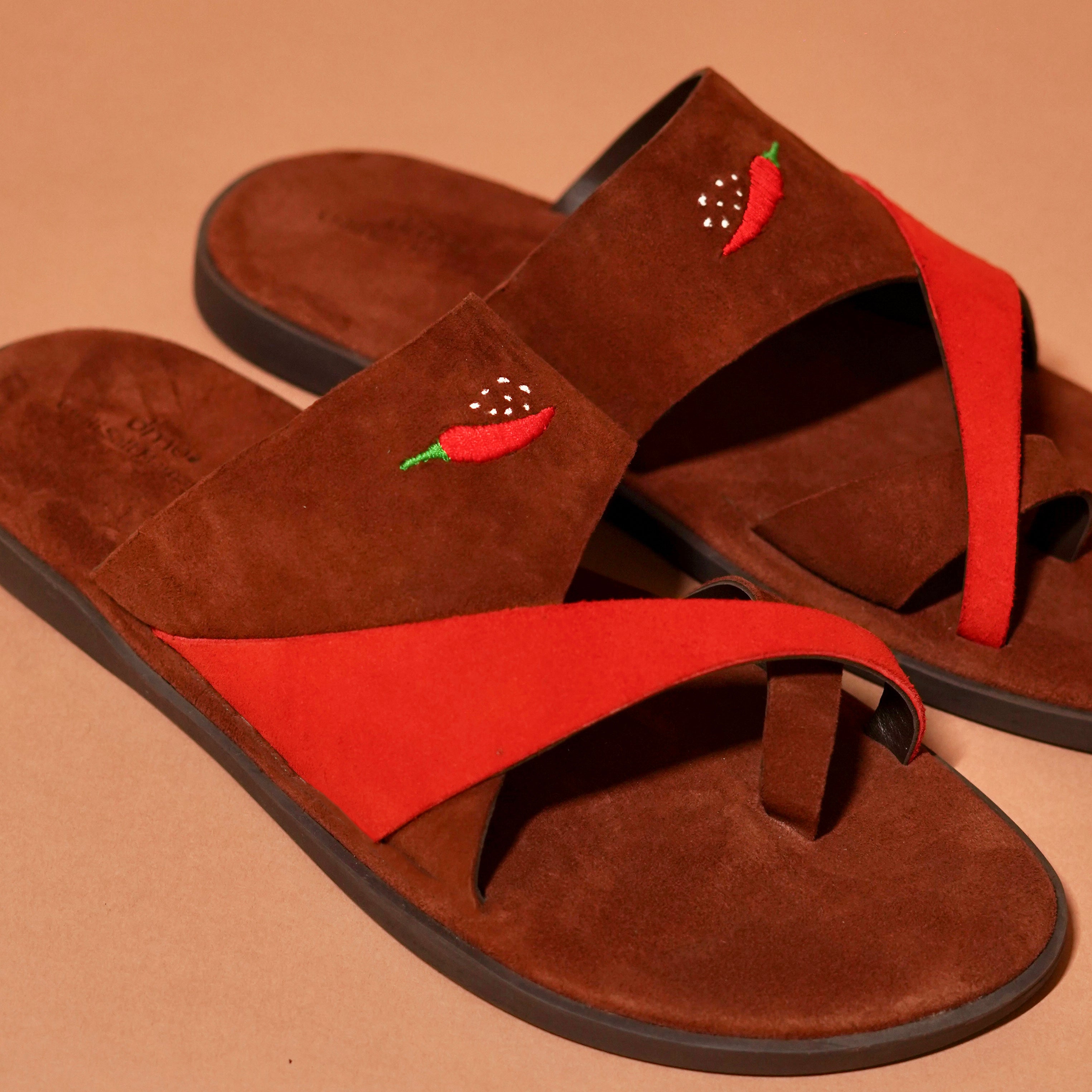 Detail of chilli embroidery on suede criss-cross strap of Chilli Slipper