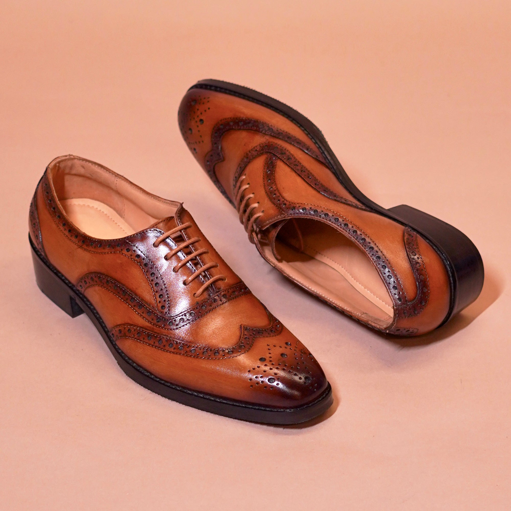Close-up of brogue perforations and tan leather detailing on Tanino Classico