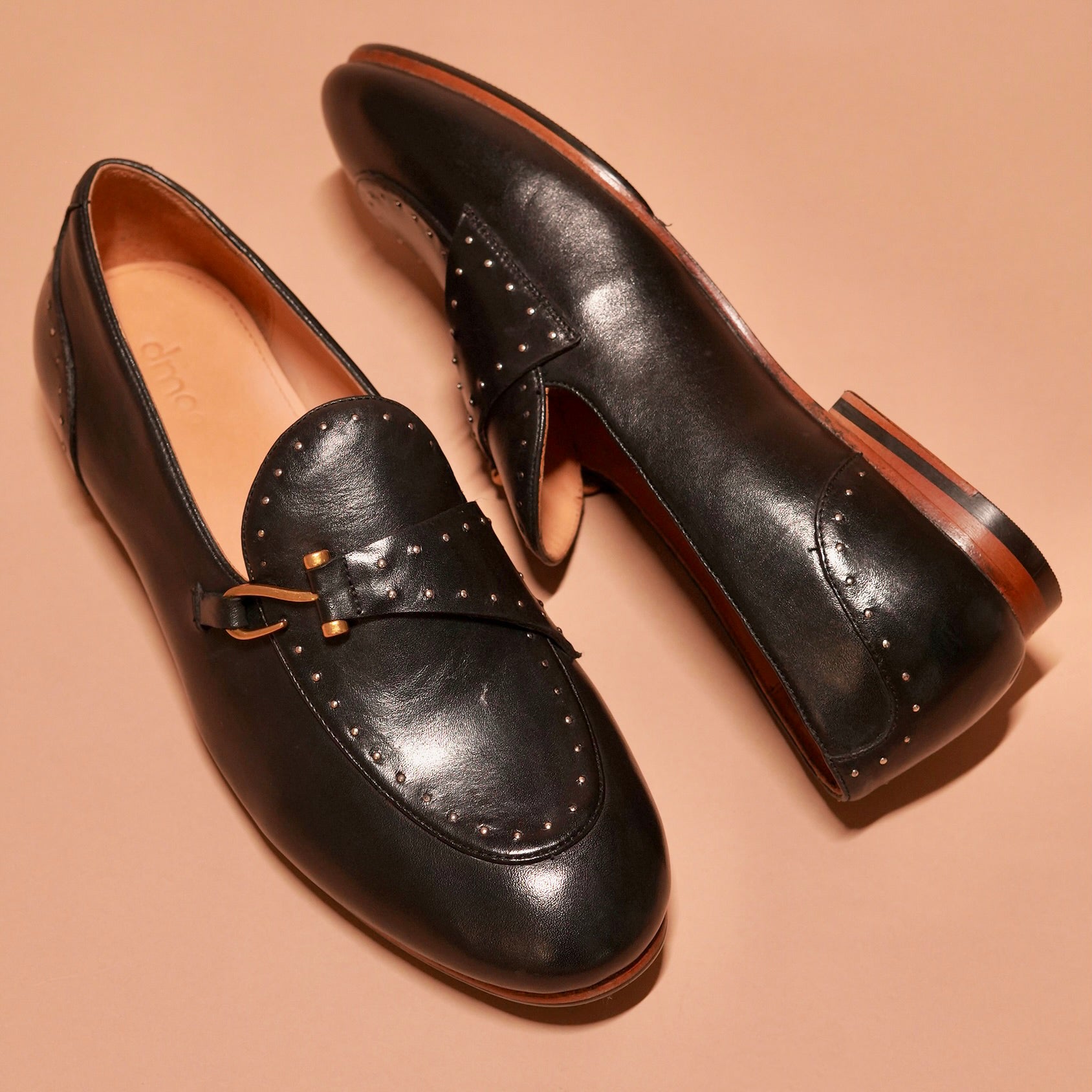 Close-up of Motivo Nero Riveto's intricate rivet details on the vamp and back.