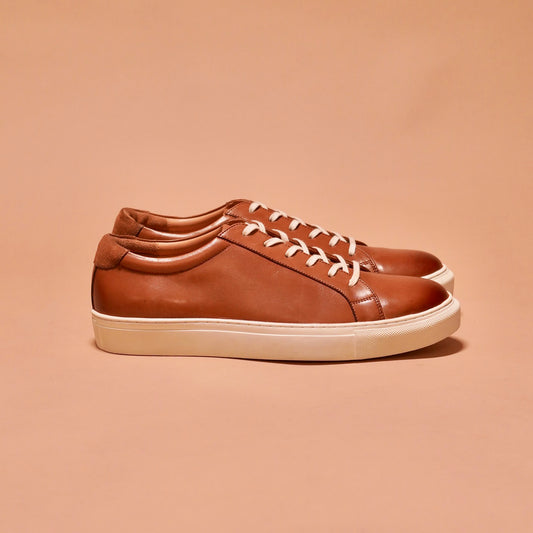Side view of Bosco tan leather sneakers showcasing the full-grain crust and classic white cup sole.
