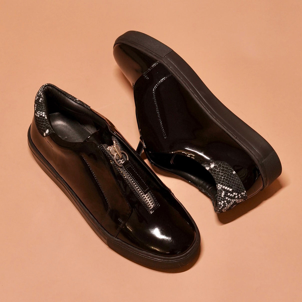 Close-up of Pigro Lustro's high-quality black patent leather and cushioned footbed.
