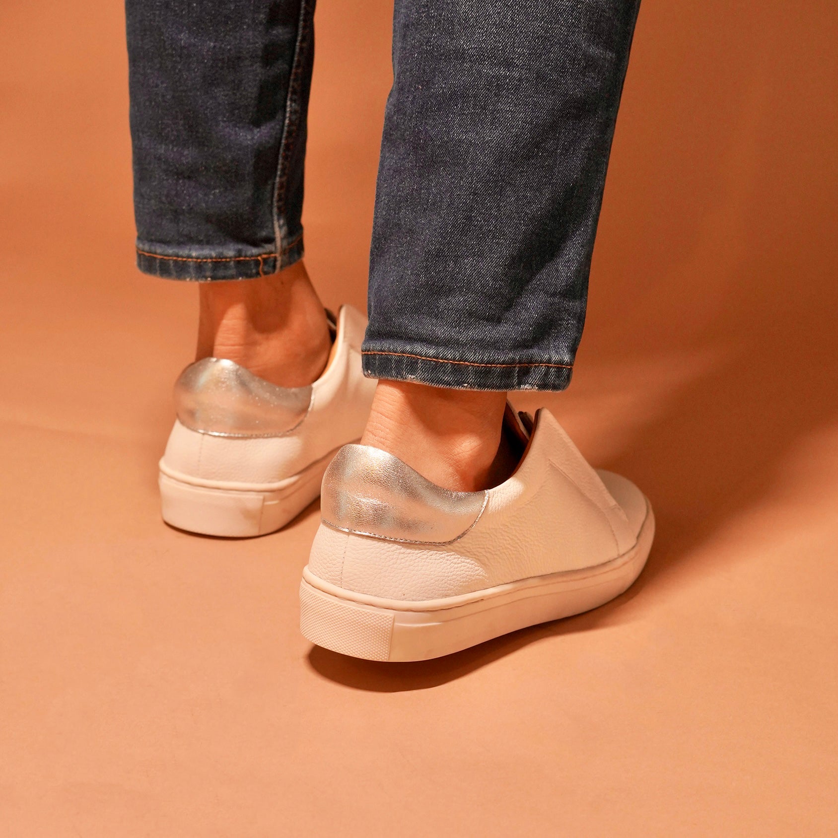 Detailed craftsmanship of Pigro Bianco white leather lazy sneakers.