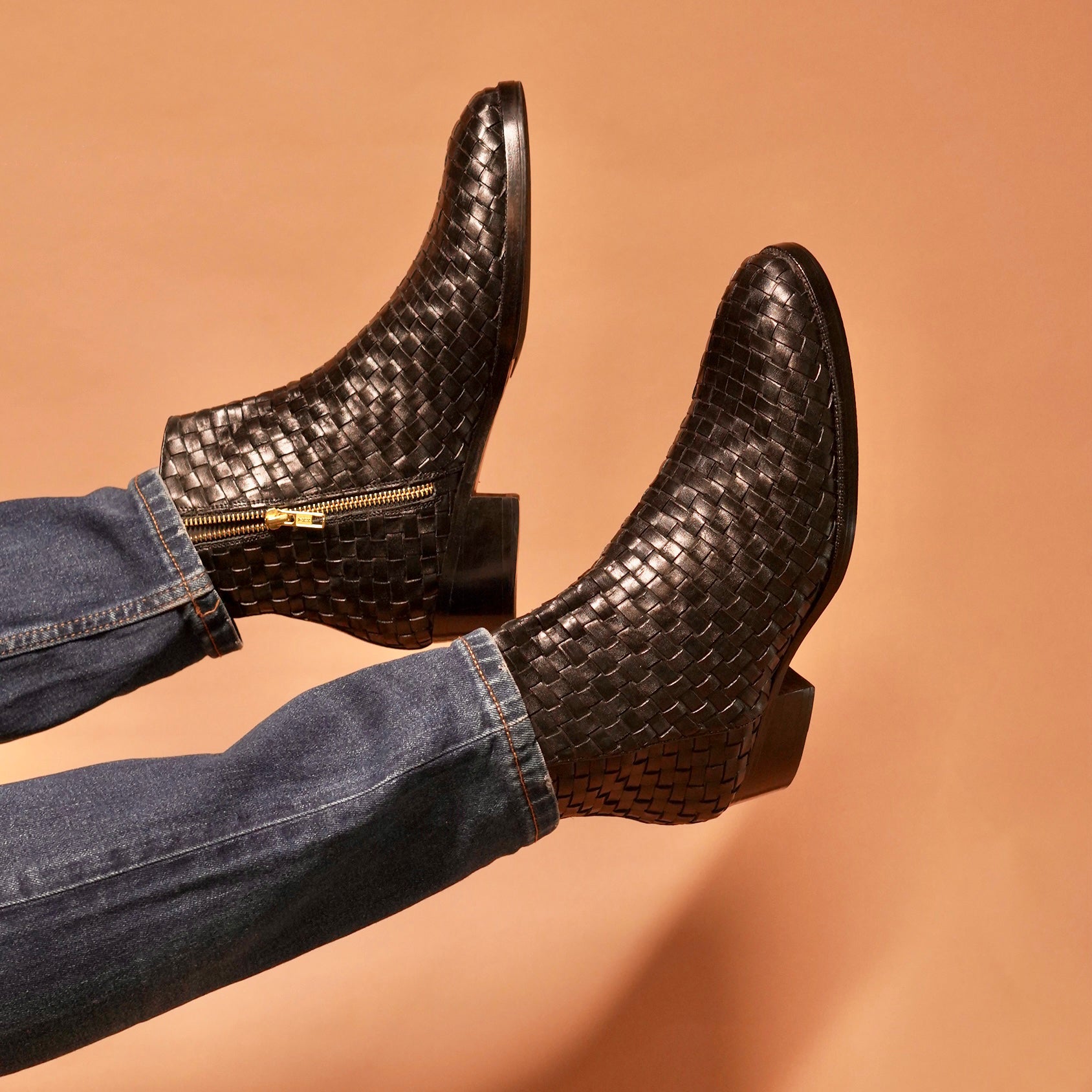 Detailed craftsmanship of Sprazzo Tesso Nero black weaved leather boots.