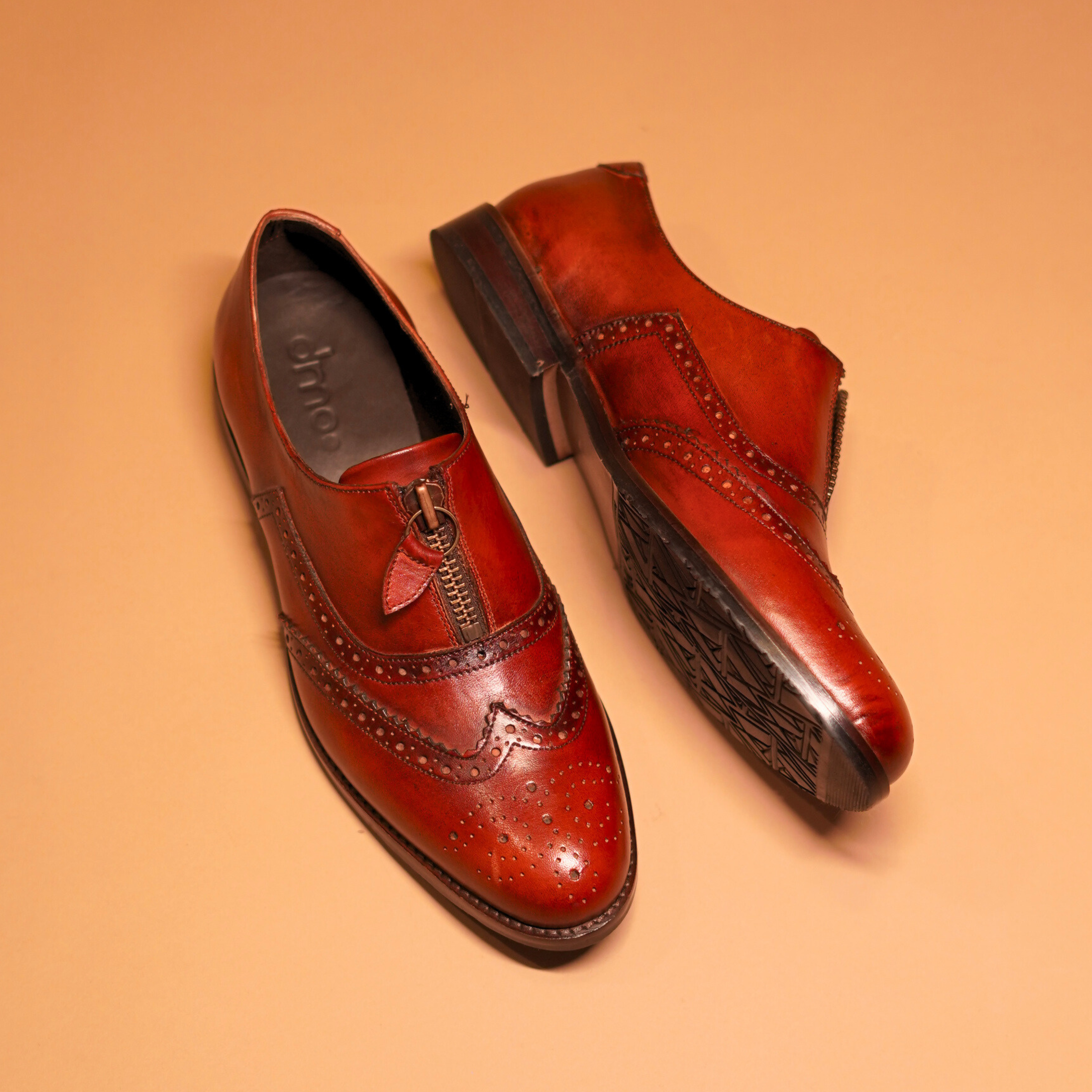 Bordo Leather Oxfords by dmodot with detailed wingtip captoe, intricate broguing, and unique central zip on rich dual-tone finish
