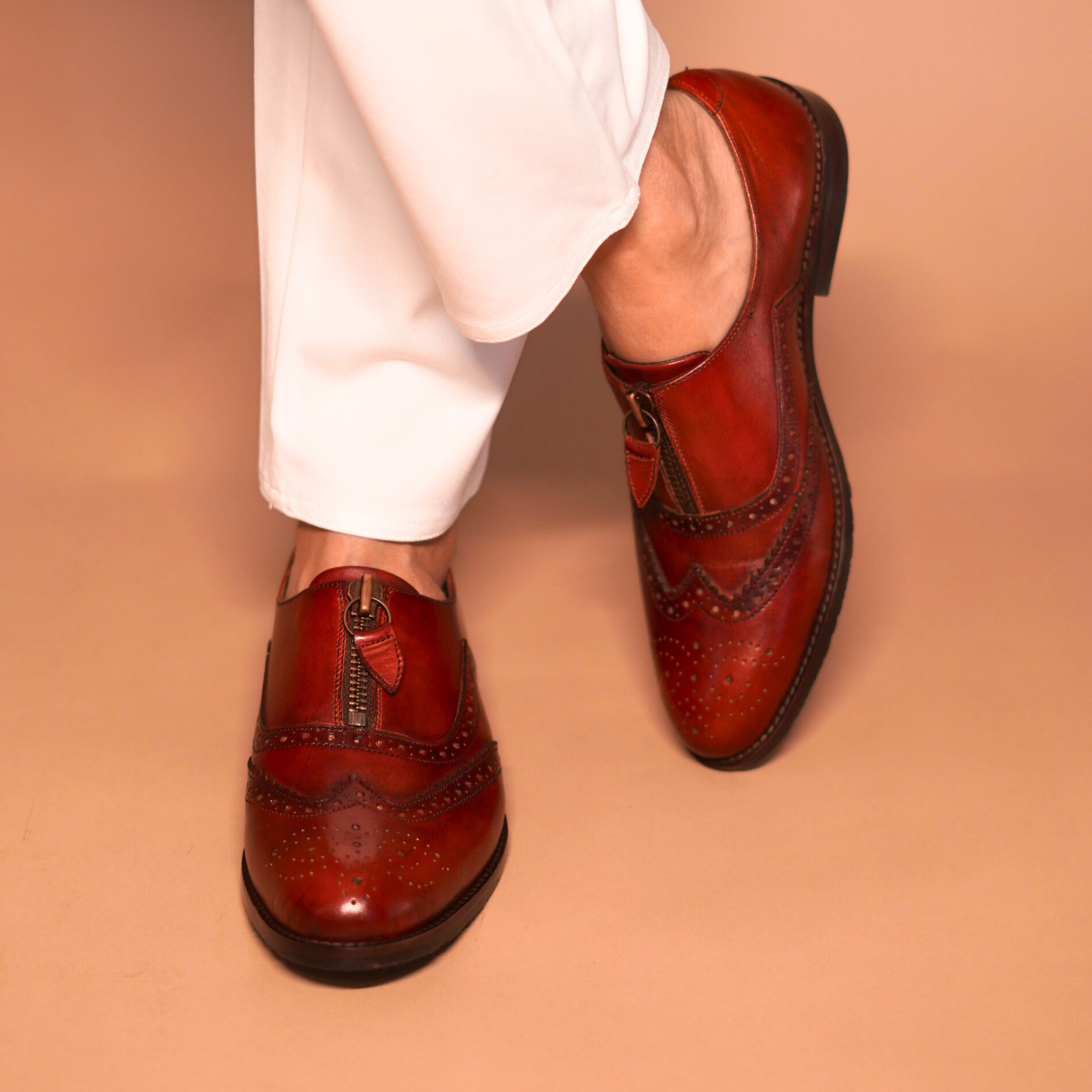 Bordo Leather Oxfords by dmodot with detailed wingtip captoe, intricate broguing, and unique central zip on rich dual-tone finish