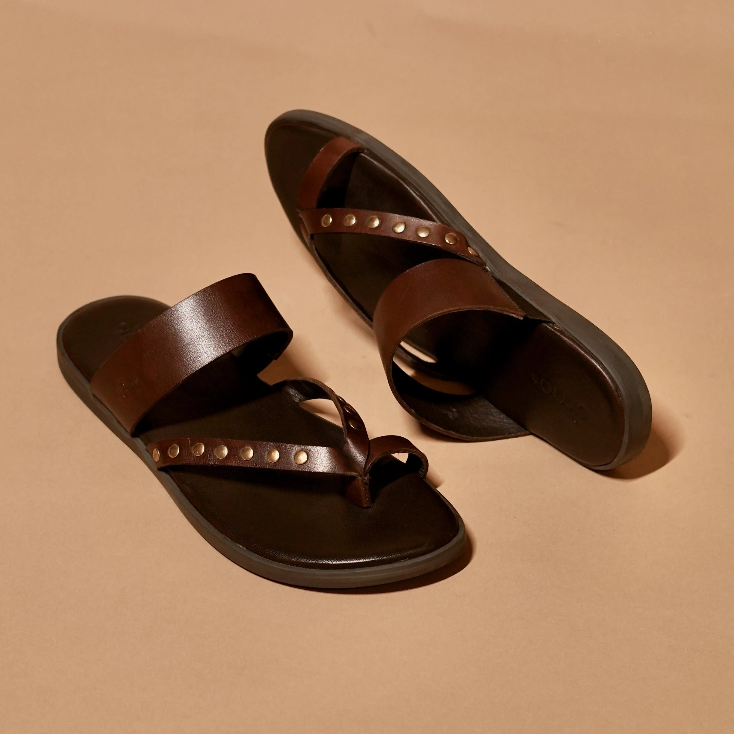 Top view of dark brown ethnic men’s sandal with toe ring