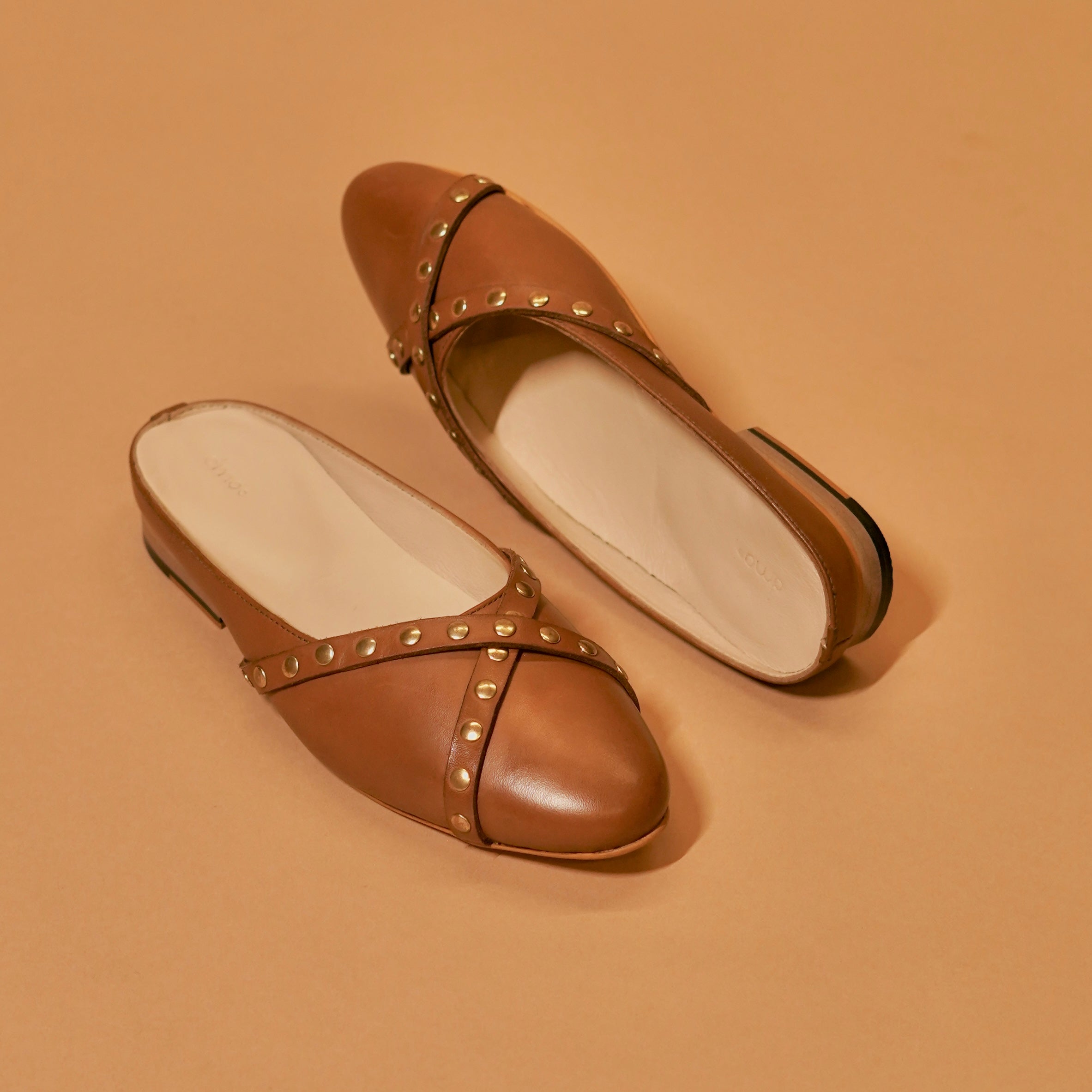 Styled brown leather mule with neutral outfit