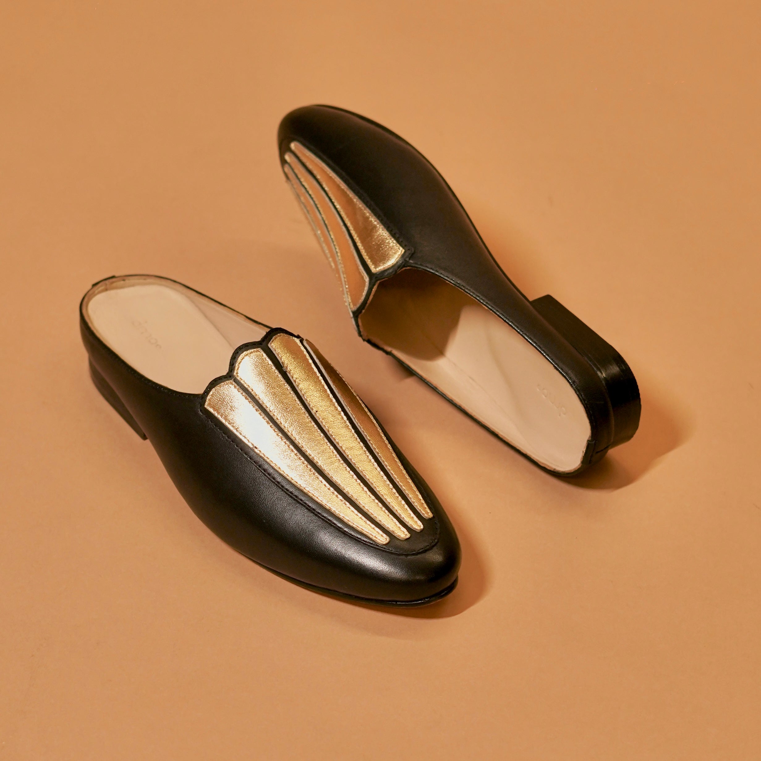 Styled black and gold mule with evening outfit