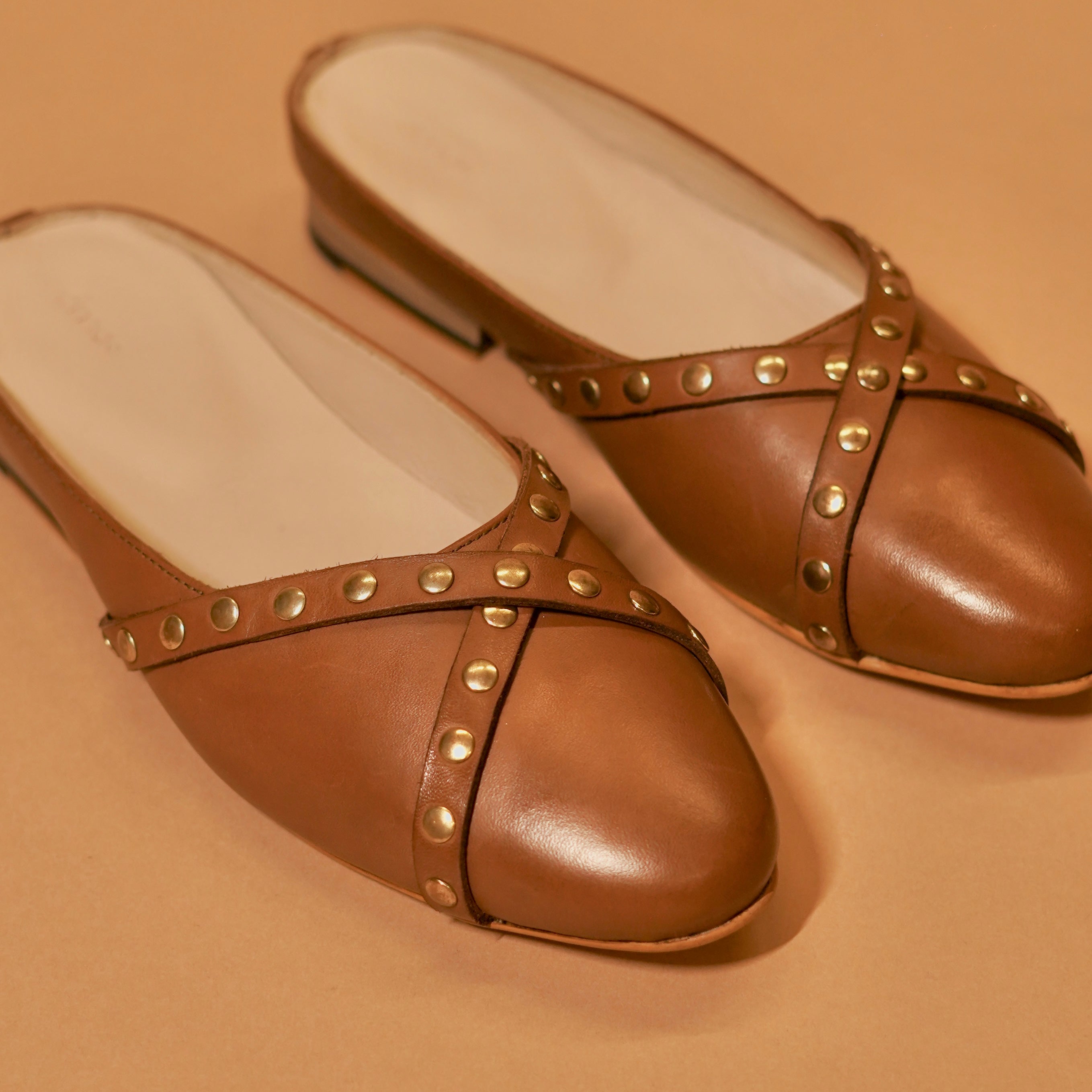 Close-up of brown leather cross straps