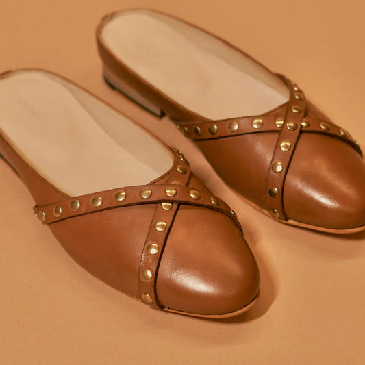 Close-up of brown leather cross straps