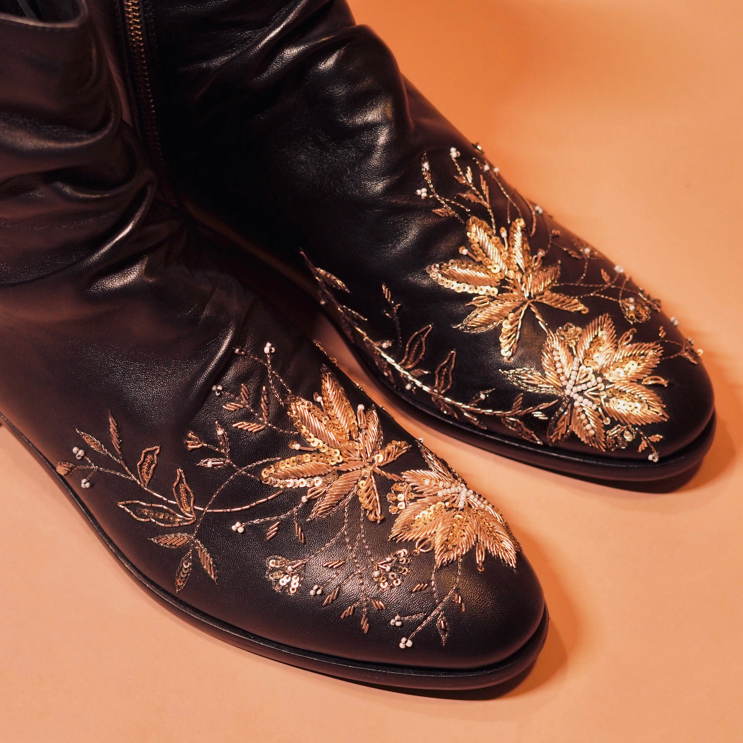 Close-up of golden zardozi detailing on Sprazo Nero Ricamo