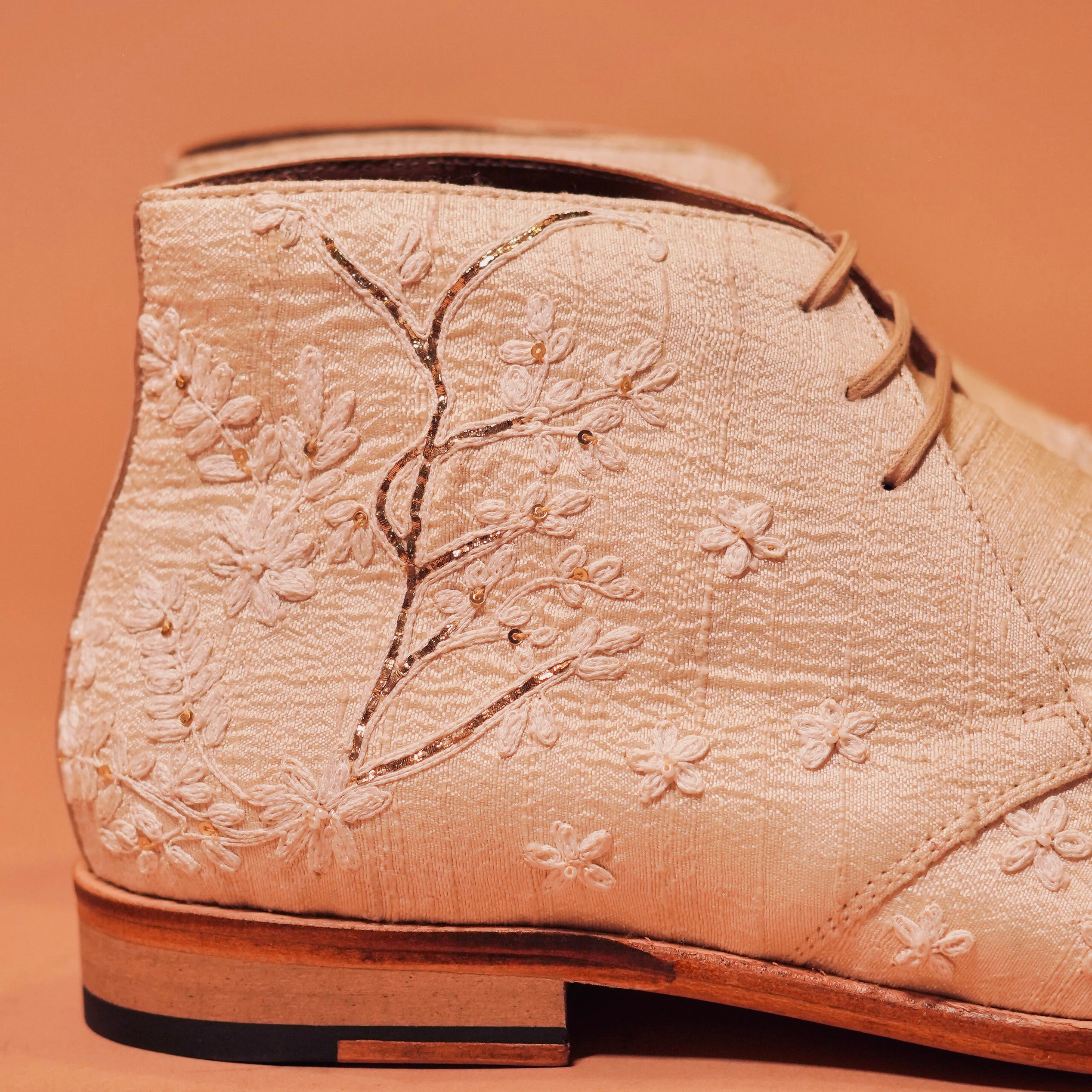 Close-up of Sprazo Nozzo’s raw silk texture and zardozi details